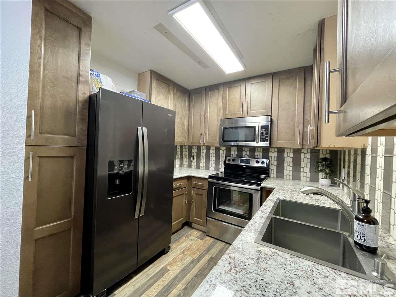 2101 Highview Court, Unit 10 Reno, NV 89512 - Photo 1 of 10 a kitchen with a refrigerator sink and stainless steel appliances