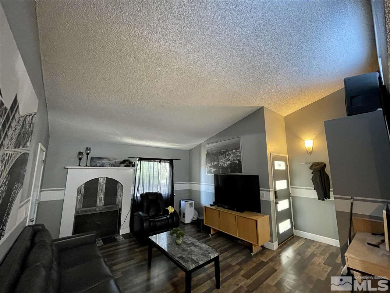 2101 Highview Court, Unit 10 Reno, NV 89512 - Photo 4 of 10 a living room with furniture and a flat screen tv