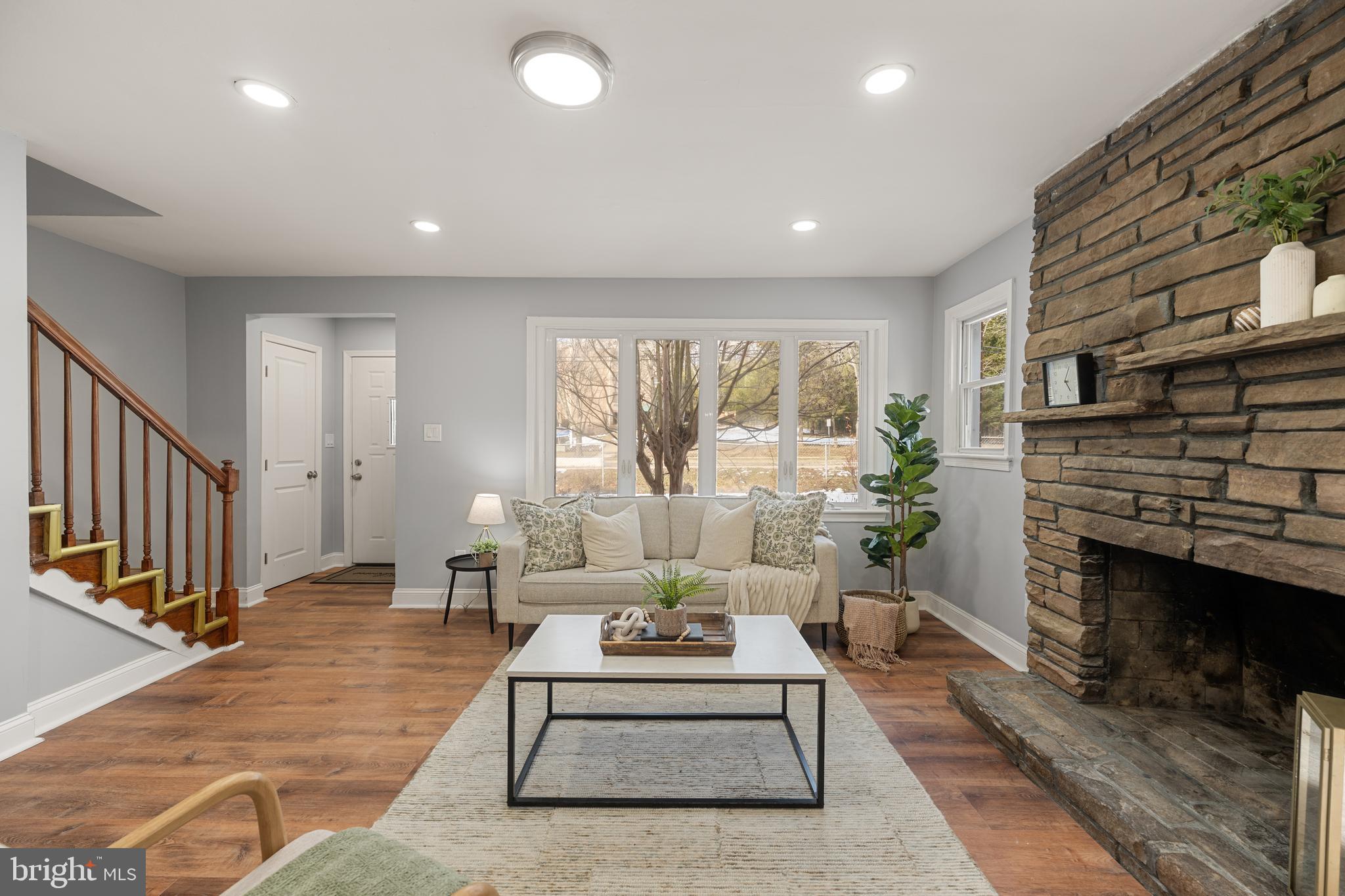 6439 Bock Road Oxon Hill, MD 20745 - Photo 13 of 38 a living room with furniture large window and a fireplace
