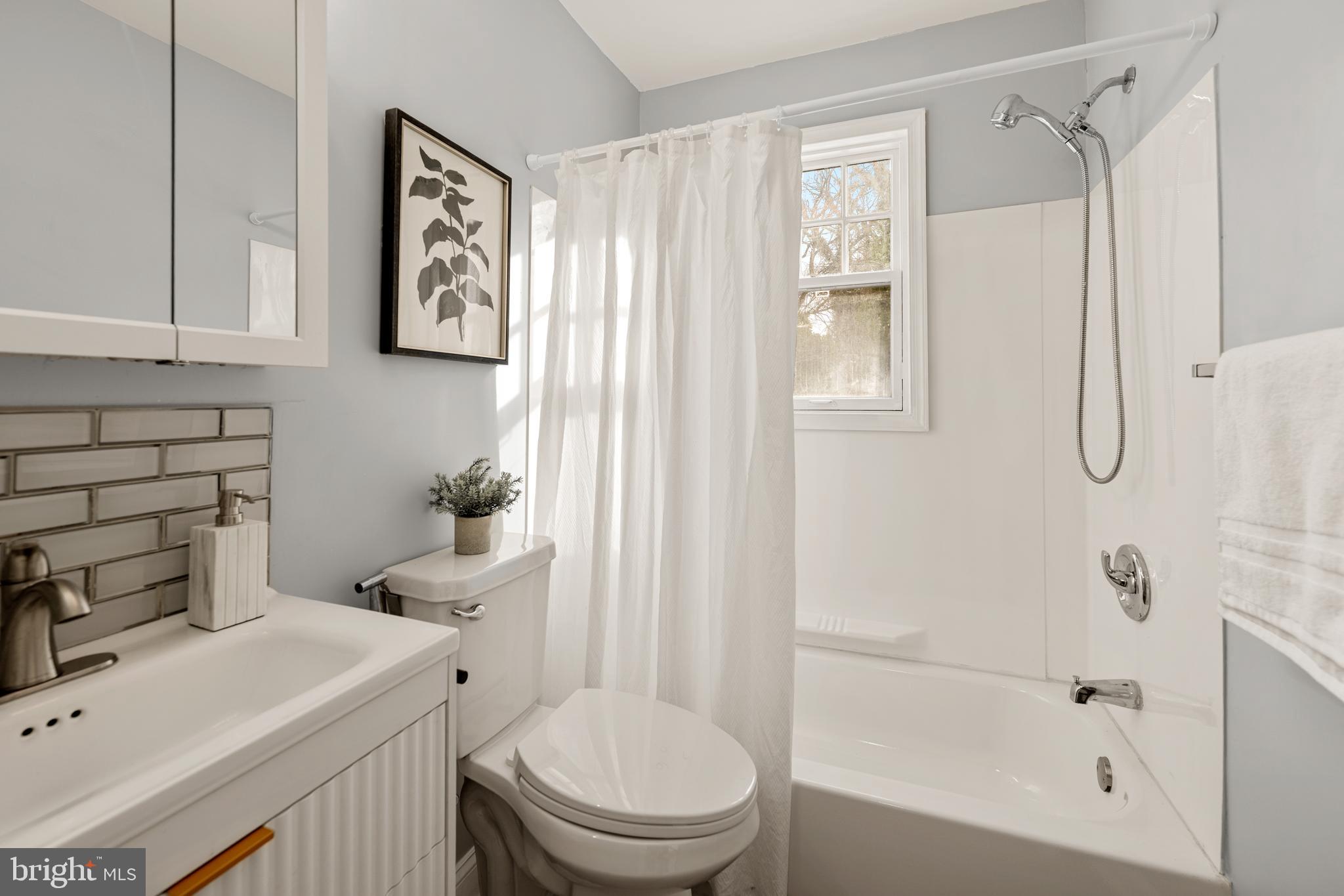 6439 Bock Road Oxon Hill, MD 20745 - Photo 18 of 38 a bathroom with a sink toilet and shower