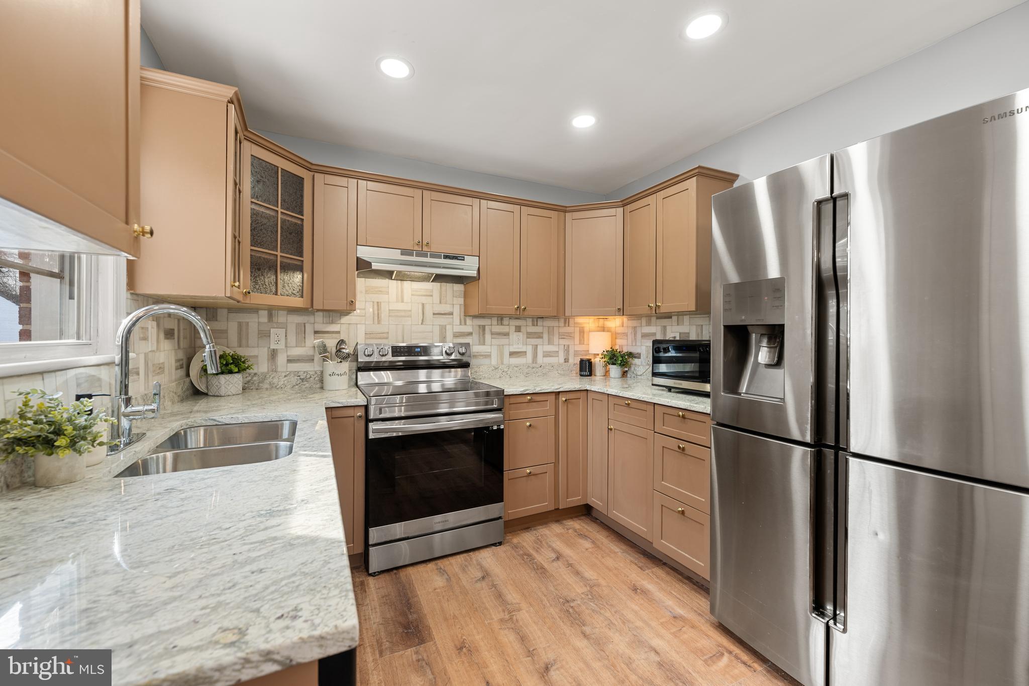 6439 Bock Road Oxon Hill, MD 20745 - Photo 2 of 38 a kitchen with stainless steel appliances granite countertop a refrigerator stove a sink and dishwasher