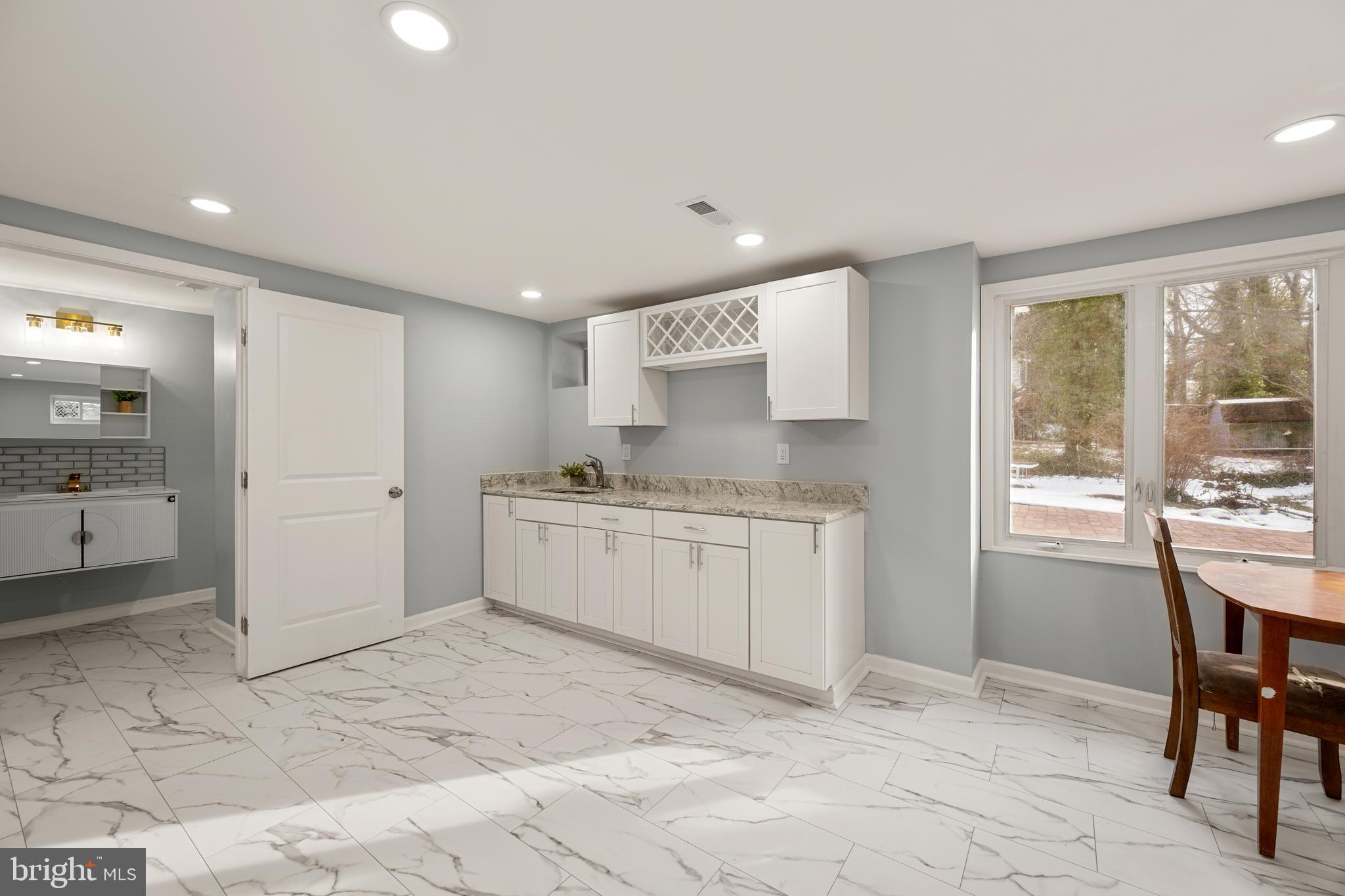 6439 Bock Road Oxon Hill, MD 20745 - Photo 27 of 38 a large white kitchen with a sink and cabinets