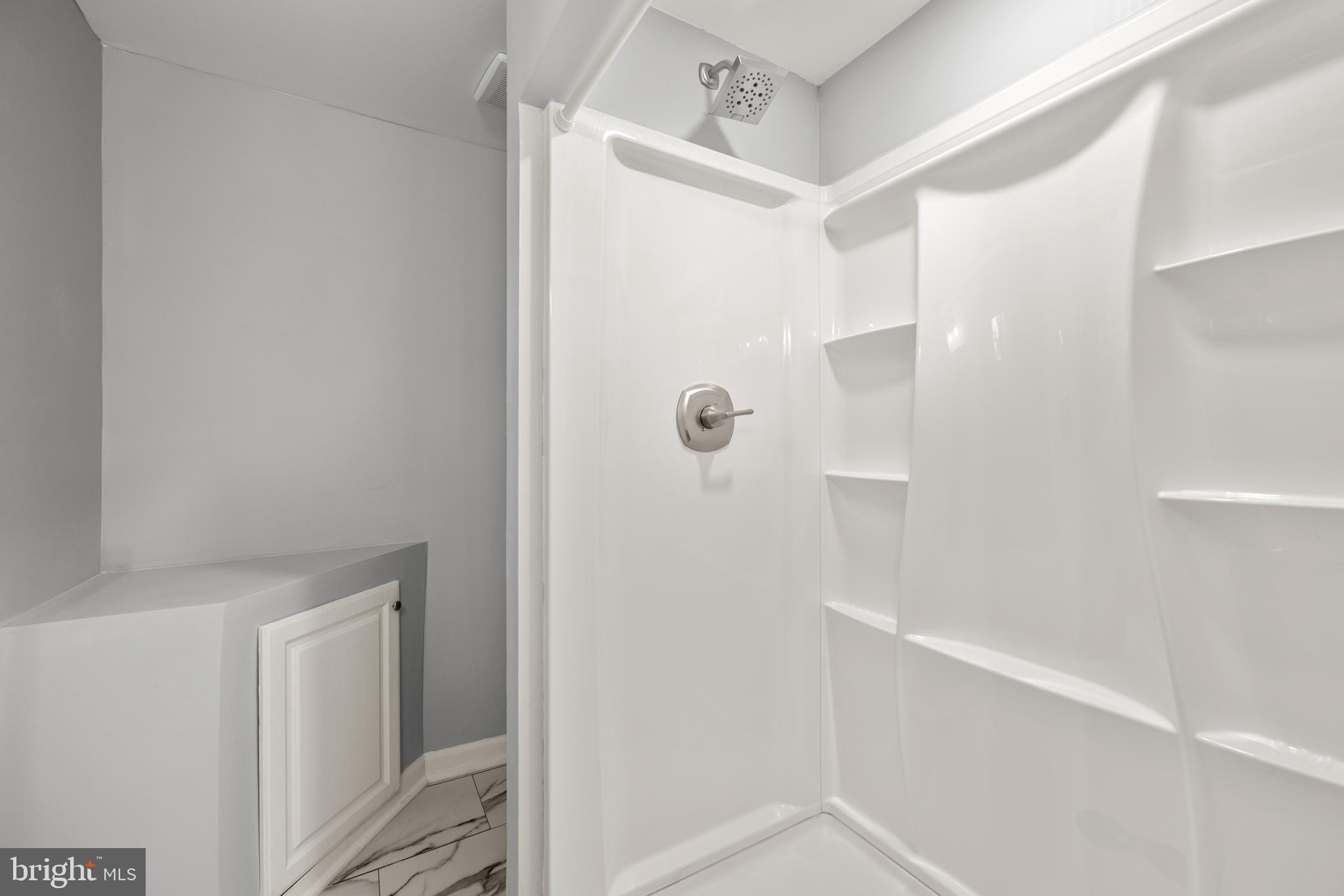 6439 Bock Road Oxon Hill, MD 20745 - Photo 32 of 38 a bathroom with a shower and a glass door