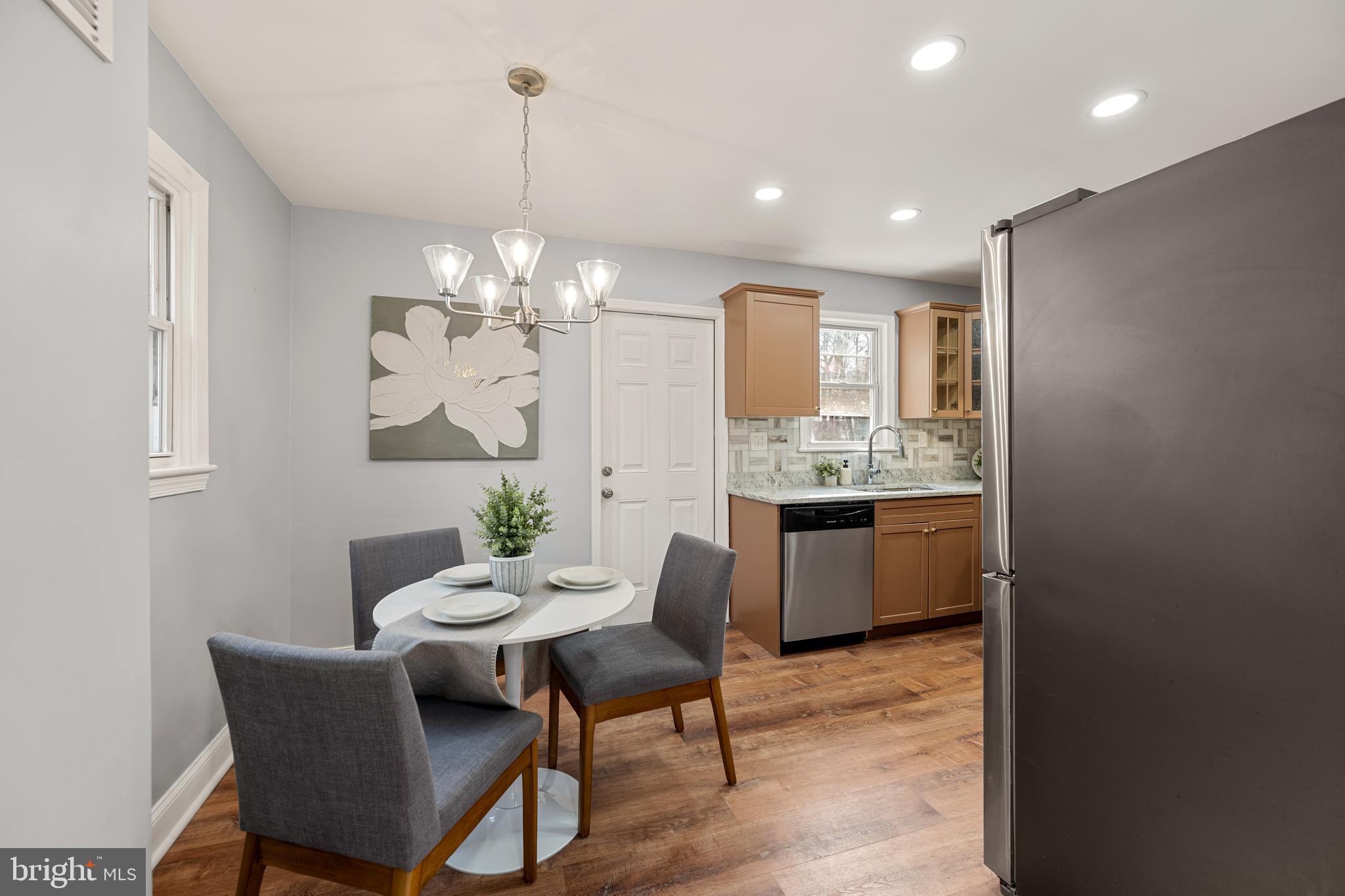 6439 Bock Road Oxon Hill, MD 20745 - Photo 9 of 38 a view of a dining room with furniture and chandelier