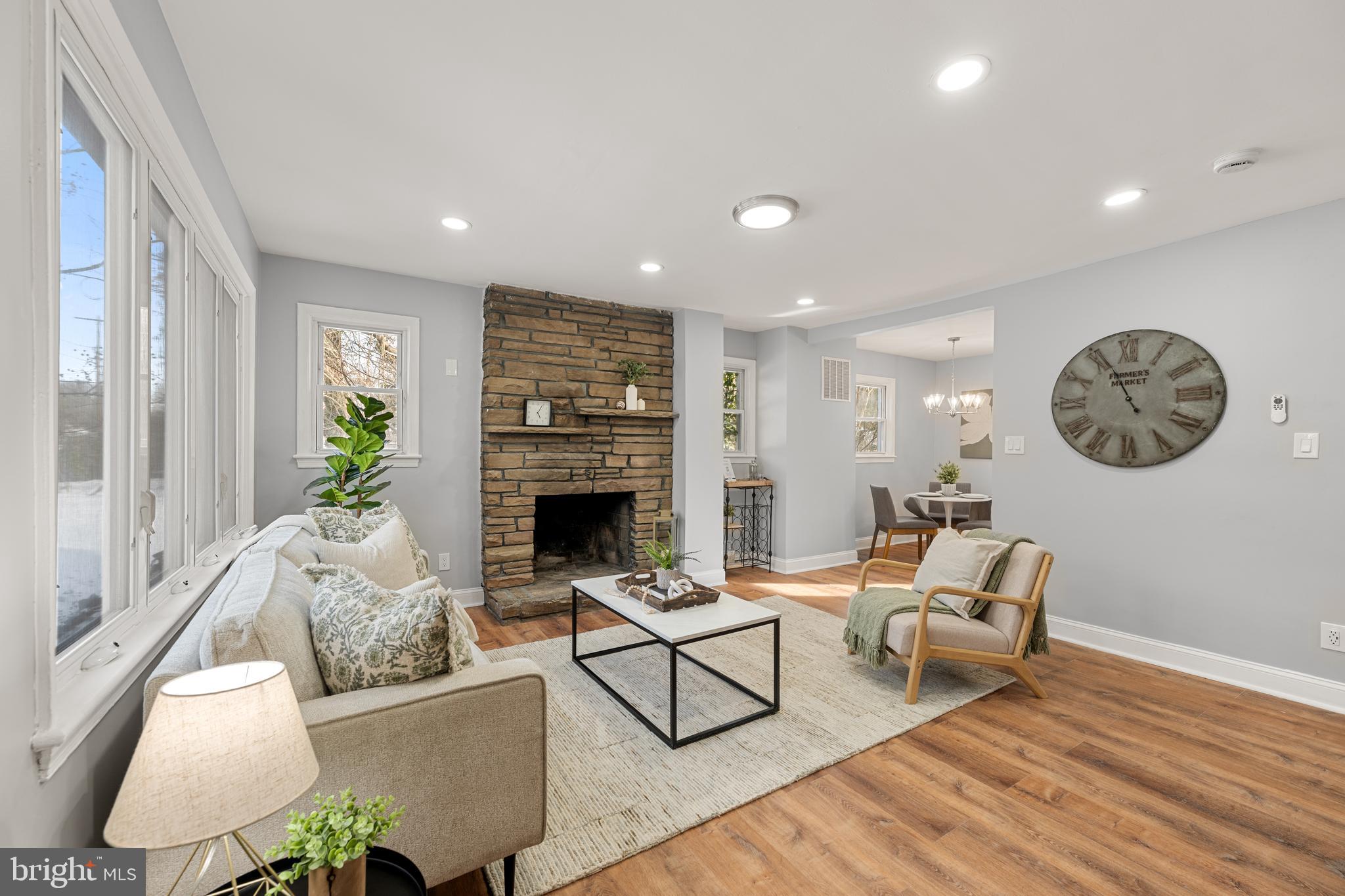 6439 Bock Road Oxon Hill, MD 20745 - Photo 10 of 38 a living room with furniture a rug a fireplace and a large window