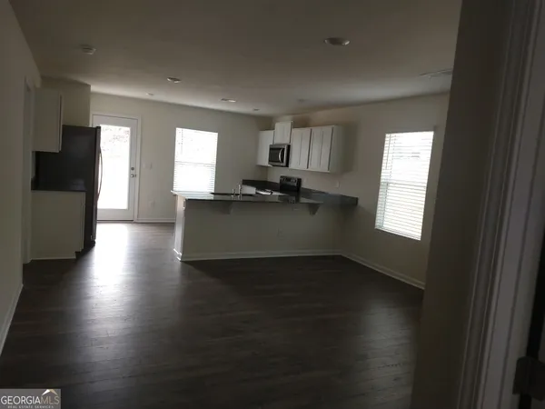 a kitchen with granite countertop a stove top oven a sink and a window