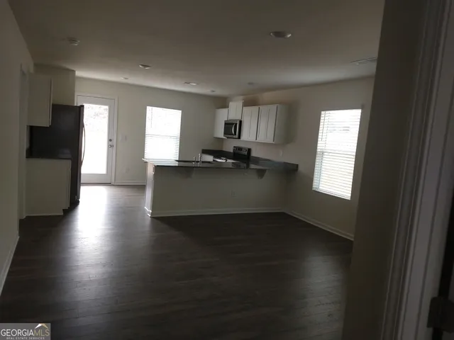 a kitchen with granite countertop a stove top oven a sink and a window