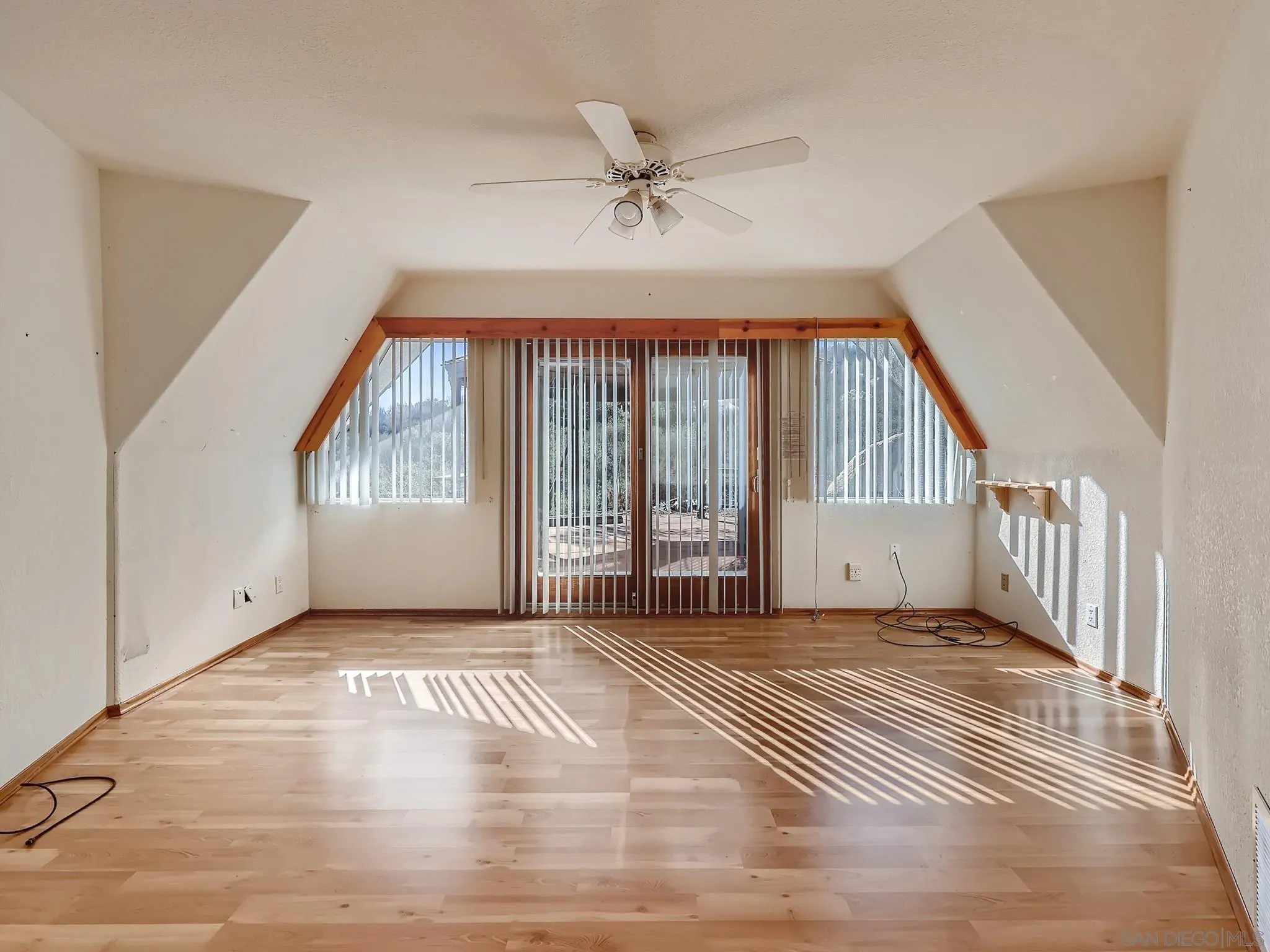 20509 Bexley Road Jamul, CA 91935 - Photo 11 of 28 a view of an empty room with wooden floor and a window