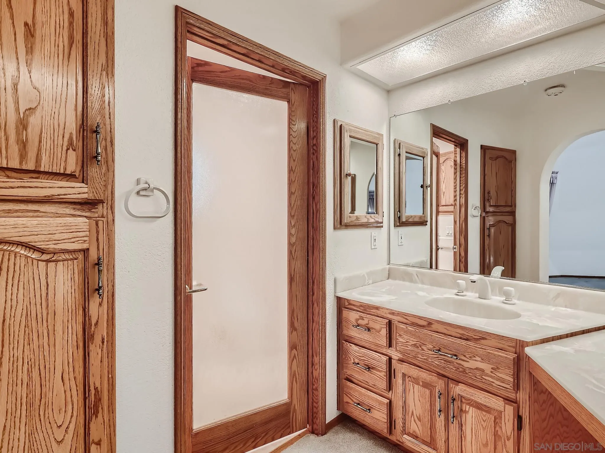 20509 Bexley Road Jamul, CA 91935 - Photo 16 of 28 a bathroom with a granite countertop sink and a mirror