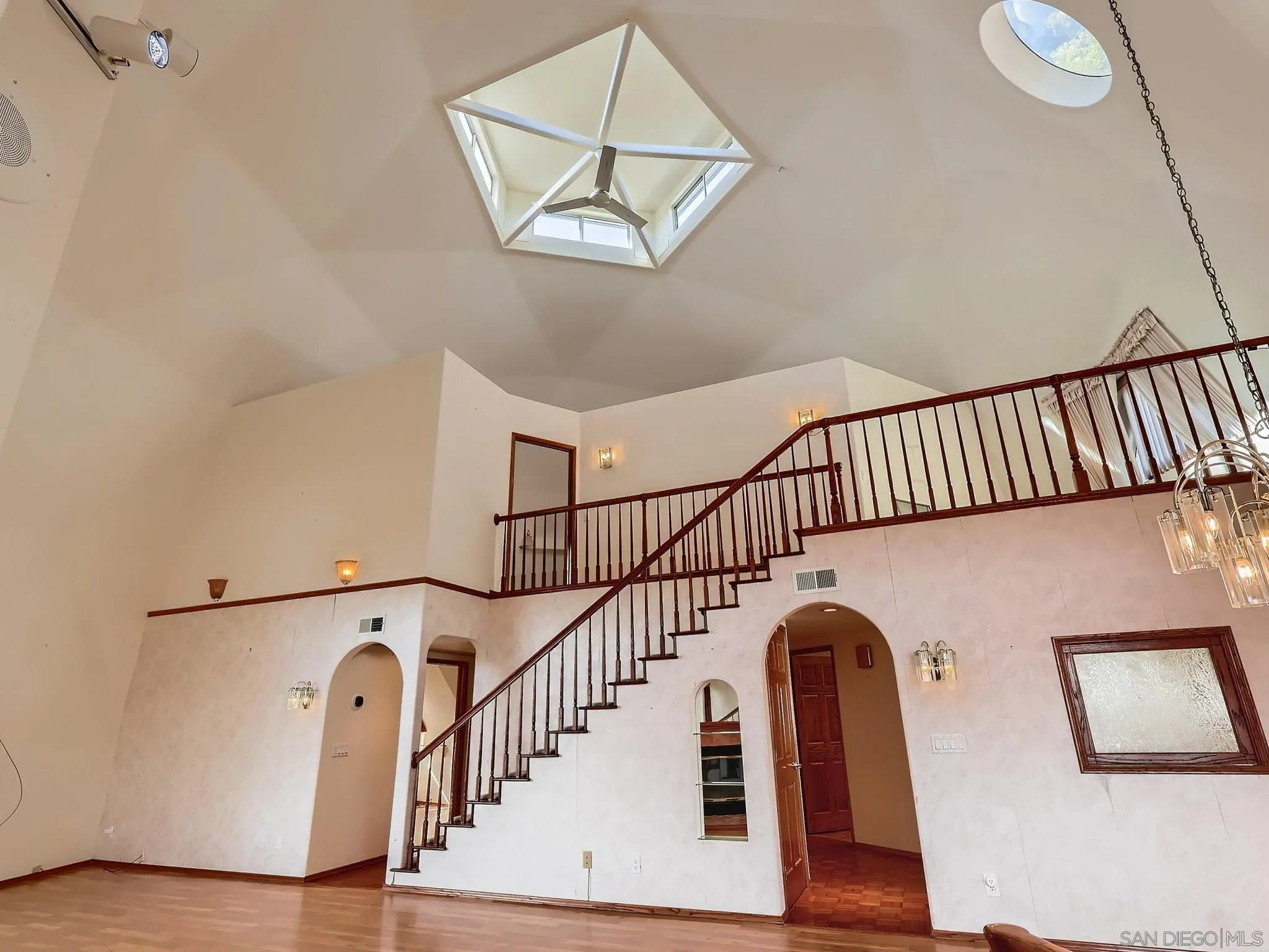 20509 Bexley Road Jamul, CA 91935 - Photo 7 of 28 a view of staircase with railing and a chandelier