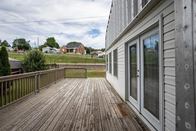 a view of a house with a wooden deck