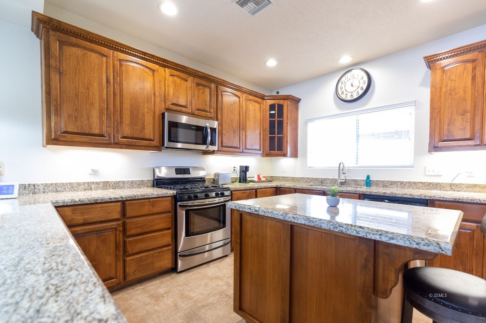 428 South Inyo Street Ridgecrest, CA 93555 - Photo 7 of 33 a kitchen with stainless steel appliances granite countertop a stove sink microwave and window