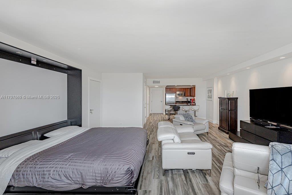 2301 Collins Avenue, Unit 1532 Miami Beach, FL 33139 - Photo 12 of 28 a bedroom with a bed and a flat screen tv