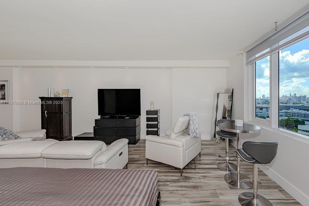 2301 Collins Avenue, Unit 1532 Miami Beach, FL 33139 - Photo 13 of 28 a living room with furniture a flat screen tv and a fireplace