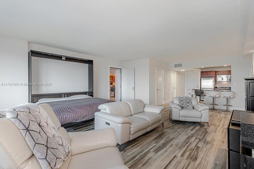 2301 Collins Avenue, Unit 1532 Miami Beach, FL 33139 - Photo 19 of 28 a bedroom with furniture and wooden floor