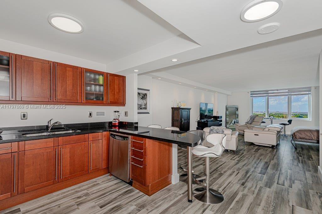 2301 Collins Avenue, Unit 1532 Miami Beach, FL 33139 - Photo 2 of 28 a kitchen with a sink a counter top space and living room area