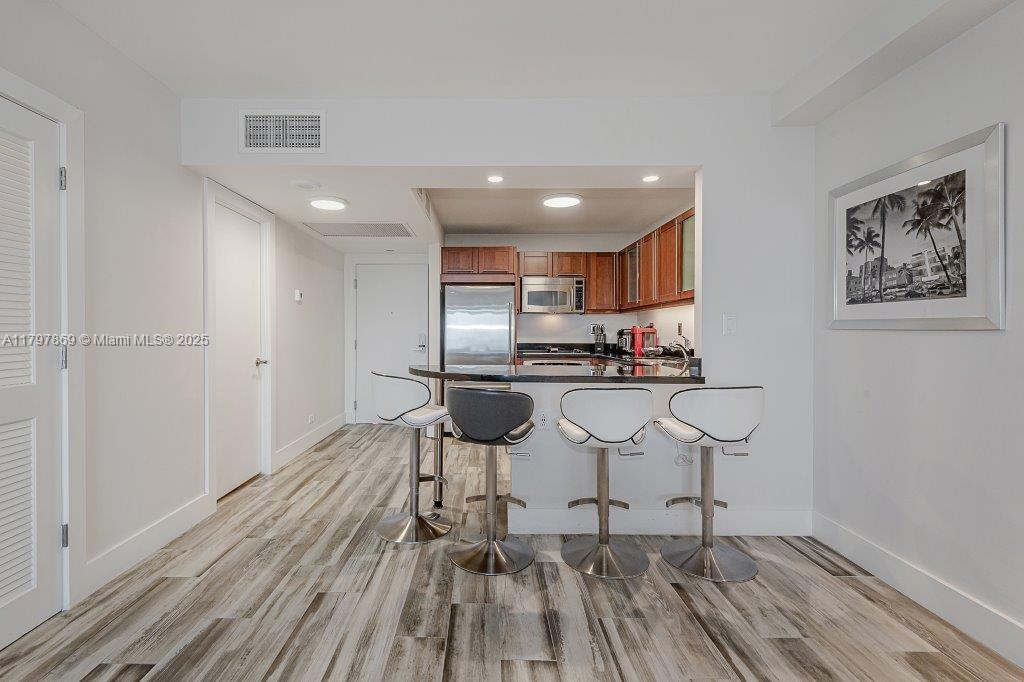 2301 Collins Avenue, Unit 1532 Miami Beach, FL 33139 - Photo 21 of 28 a kitchen with stainless steel appliances granite countertop a refrigerator and a stove top oven