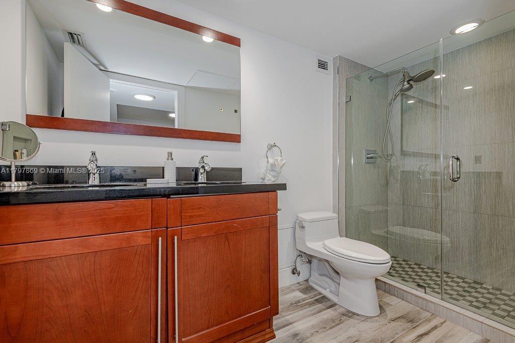 2301 Collins Avenue, Unit 1532 Miami Beach, FL 33139 - Photo 27 of 28 a bathroom with a toilet sink and shower