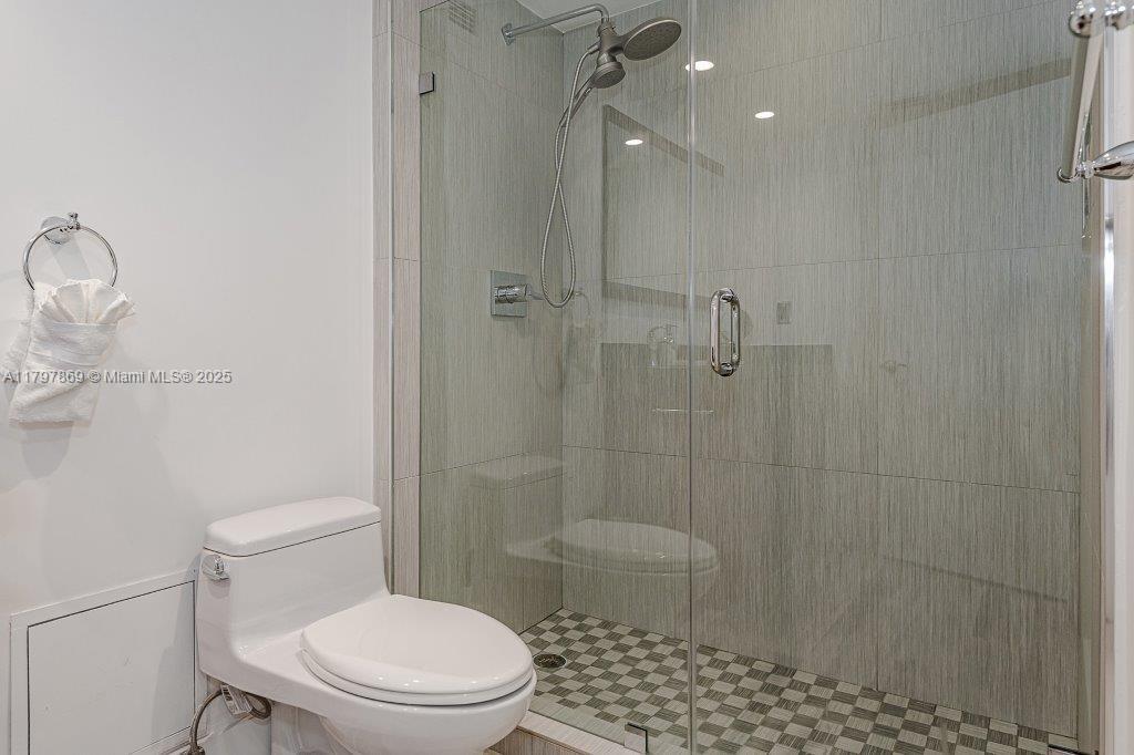2301 Collins Avenue, Unit 1532 Miami Beach, FL 33139 - Photo 28 of 28 a white toilet sitting next to a bathroom sink
