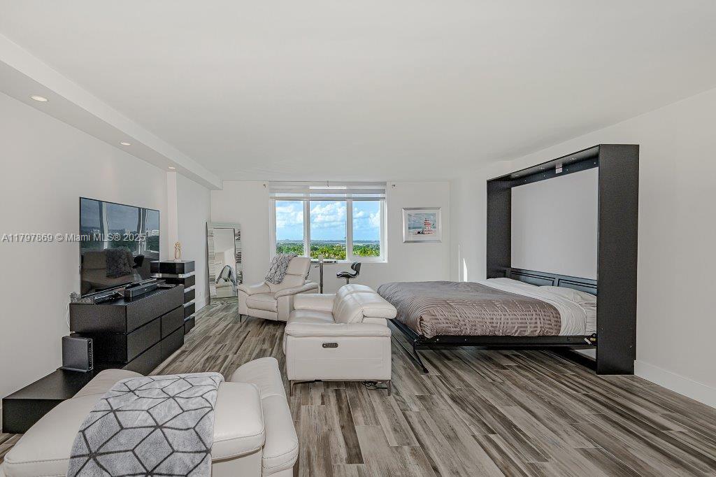 2301 Collins Avenue, Unit 1532 Miami Beach, FL 33139 - Photo 5 of 28 a bedroom with a bed and wooden floor