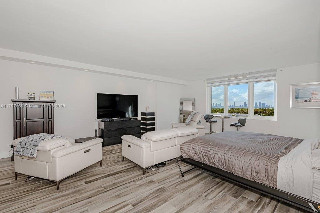 2301 Collins Avenue, Unit 1532 Miami Beach, FL 33139 - Photo 7 of 28 a bedroom with two beds and a flat screen tv