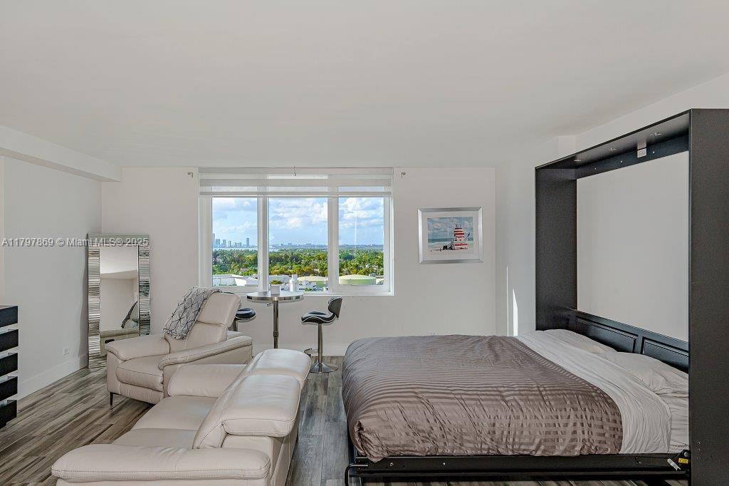 2301 Collins Avenue, Unit 1532 Miami Beach, FL 33139 - Photo 8 of 28 a bedroom with a large bed and a large window