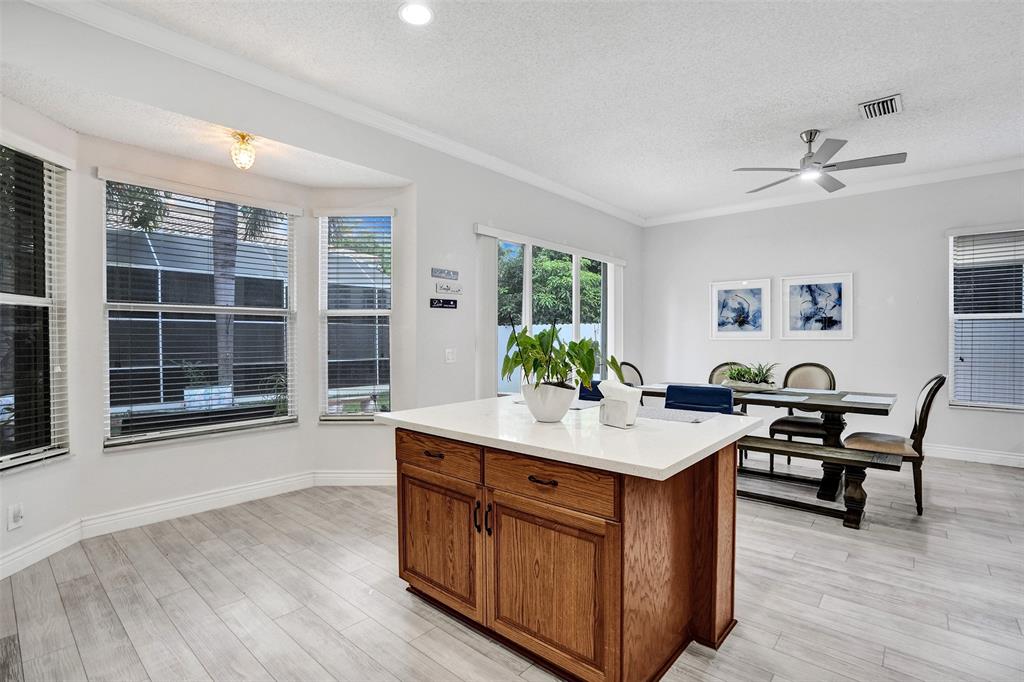13129 Southwest 32nd Street Miramar, FL 33027 - Photo 14 of 38 a room with a table chairs and wooden floor