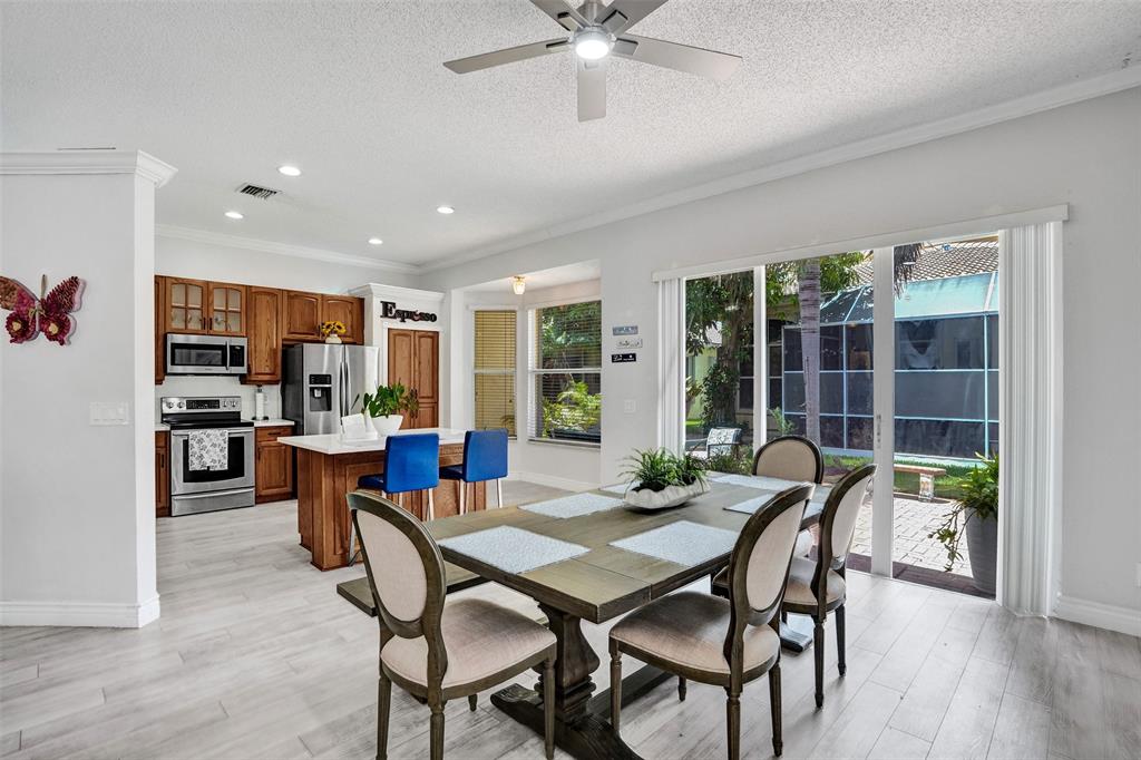 13129 Southwest 32nd Street Miramar, FL 33027 - Photo 16 of 38 a view of a dining room with furniture window and wooden floor