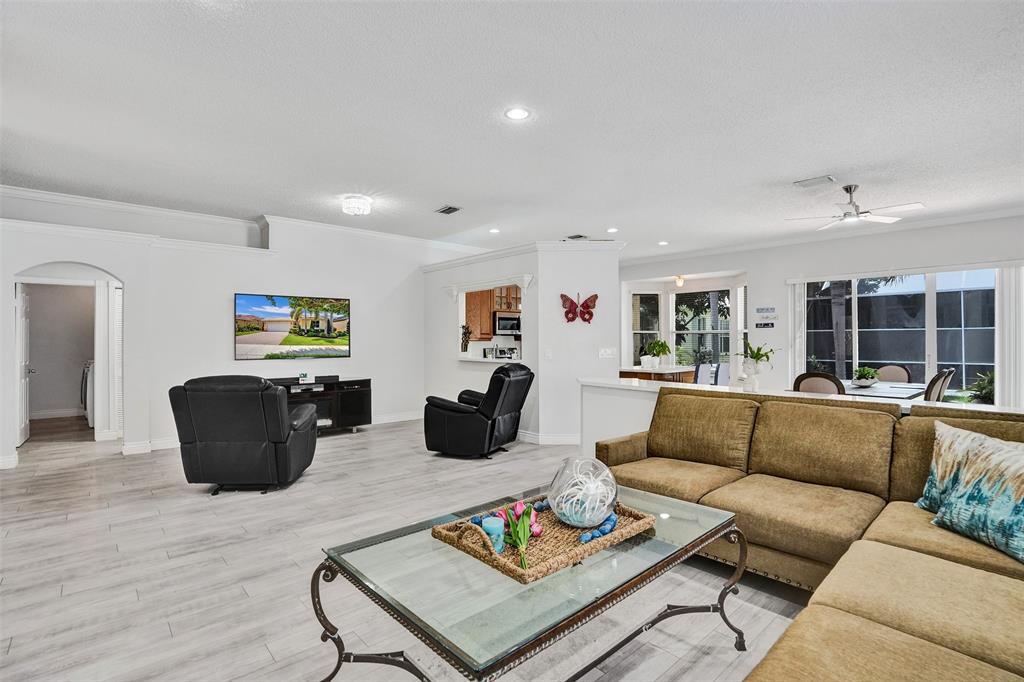 13129 Southwest 32nd Street Miramar, FL 33027 - Photo 18 of 38 a living room with furniture and wooden floor