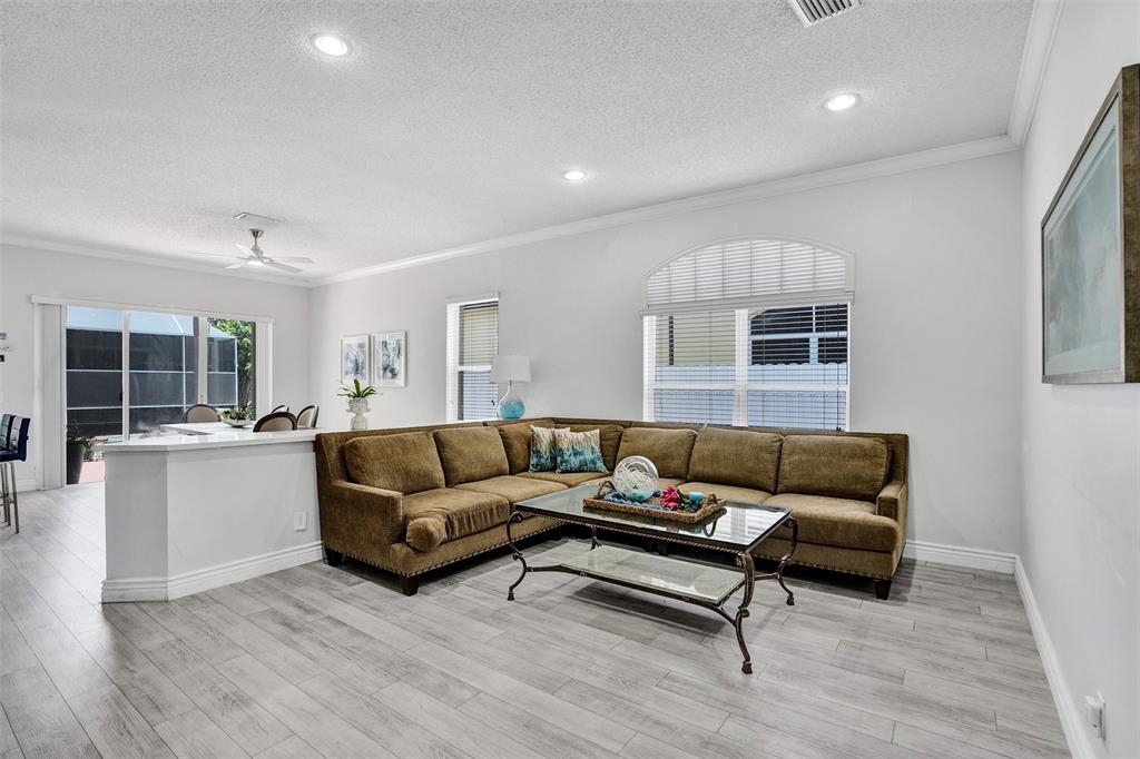 13129 Southwest 32nd Street Miramar, FL 33027 - Photo 19 of 38 a living room with furniture and a wooden floor