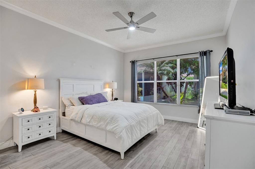 13129 Southwest 32nd Street Miramar, FL 33027 - Photo 21 of 38 a bedroom with a large bed and a large window