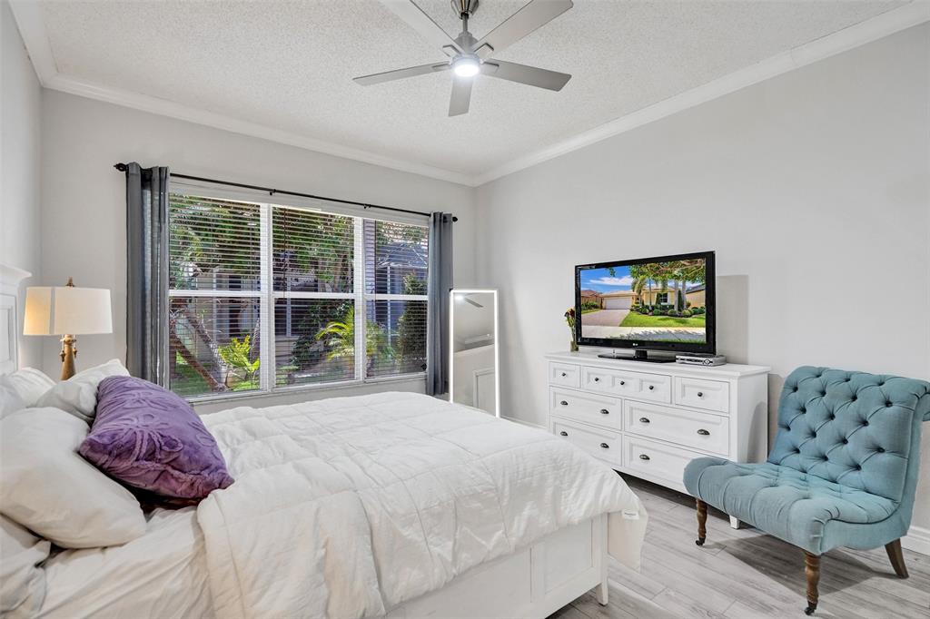 13129 Southwest 32nd Street Miramar, FL 33027 - Photo 22 of 38 a bedroom with a bed and a flat screen tv