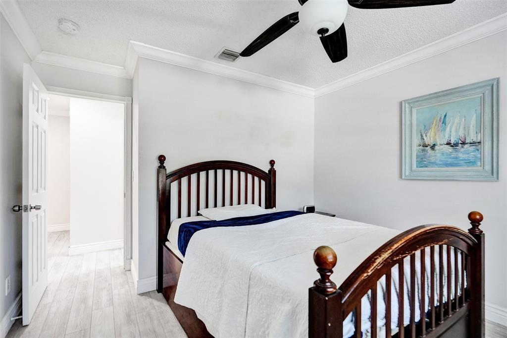 13129 Southwest 32nd Street Miramar, FL 33027 - Photo 26 of 38 a bedroom with a bed and wooden floor