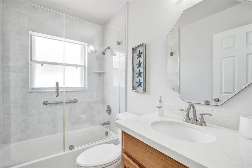 13129 Southwest 32nd Street Miramar, FL 33027 - Photo 28 of 38 a bathroom with a granite countertop sink toilet and shower
