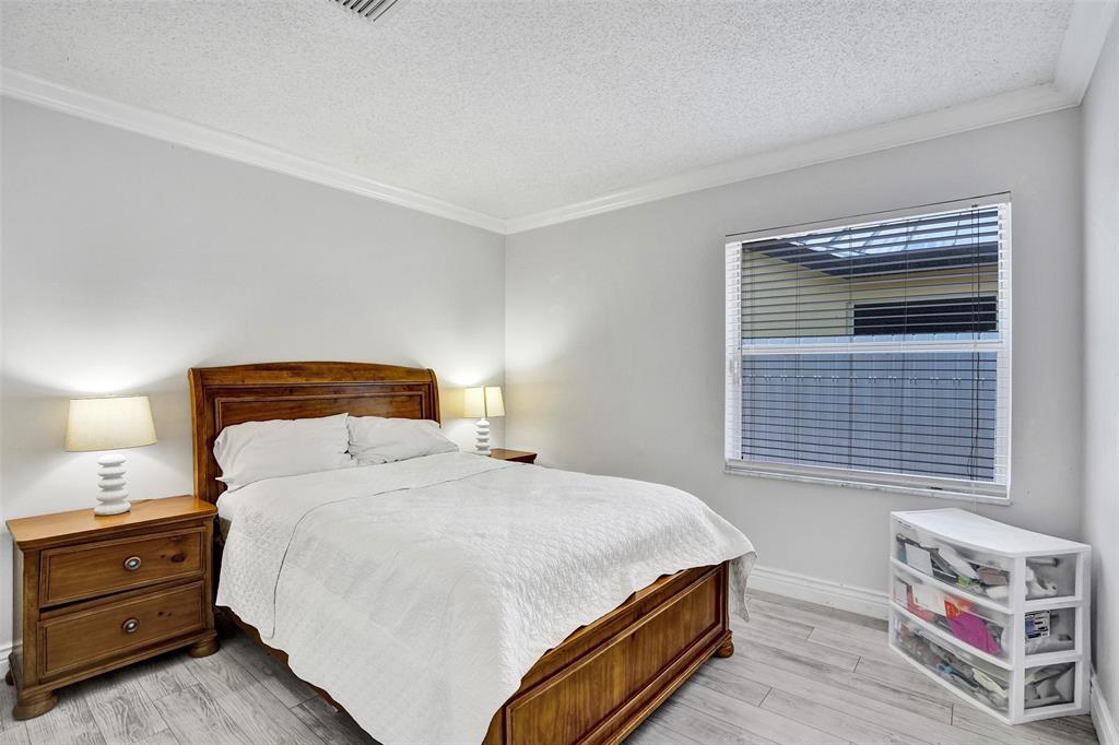 13129 Southwest 32nd Street Miramar, FL 33027 - Photo 29 of 38 a bedroom with a bed and a window