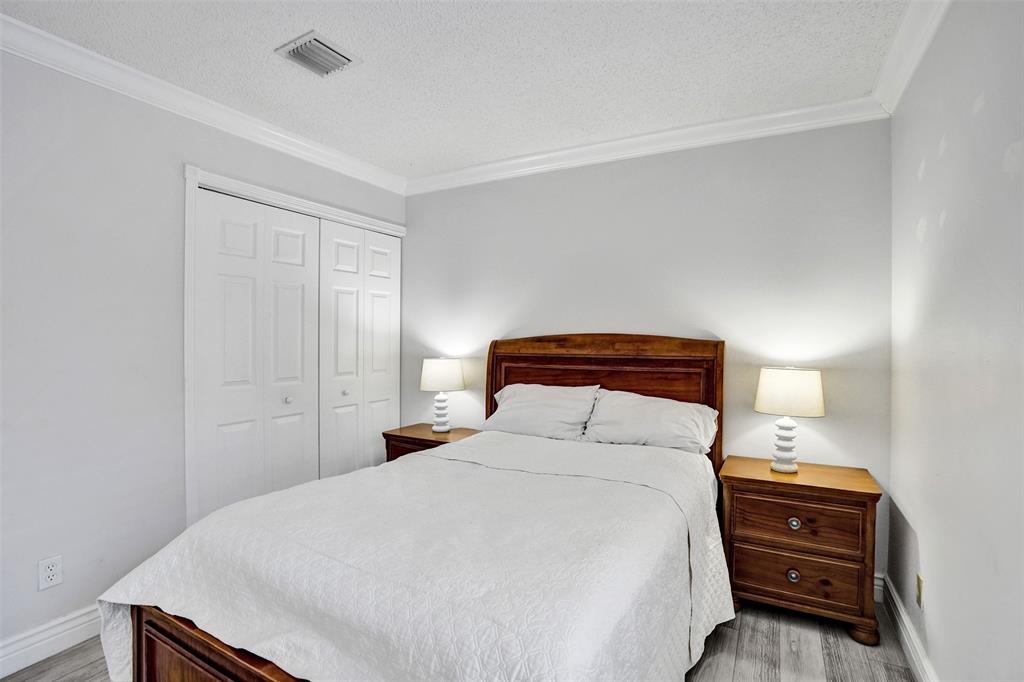 13129 Southwest 32nd Street Miramar, FL 33027 - Photo 30 of 38 a bedroom with a bed and a lamp