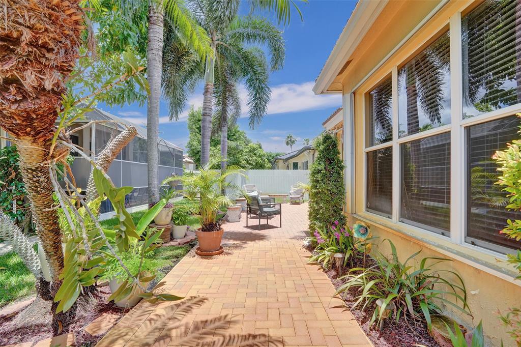 13129 Southwest 32nd Street Miramar, FL 33027 - Photo 32 of 38 a potted plant sitting in front of a house
