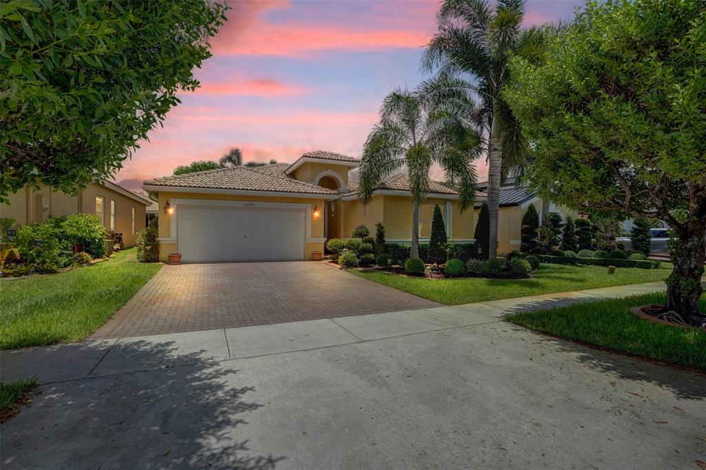 13129 Southwest 32nd Street Miramar, FL 33027 - Photo 34 of 38 a front view of house with yard and green space