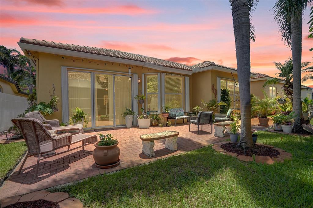 13129 Southwest 32nd Street Miramar, FL 33027 - Photo 35 of 38 a view of a house with backyard sitting area and garden