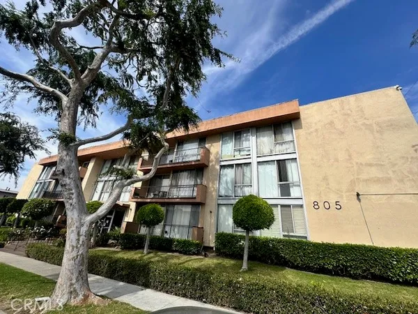 a kitchen with stainless steel appliances a white stove top oven and white cabinets