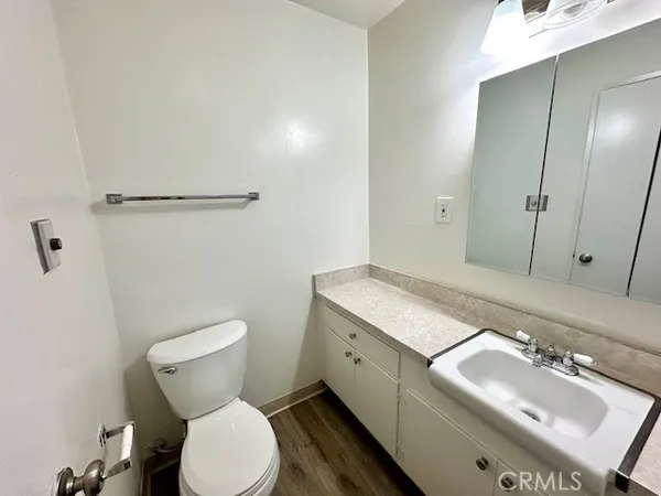 a bathroom with a granite countertop sink mirror vanity and toilet