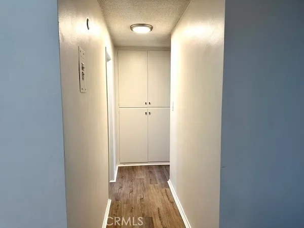 a view of hallway with wooden floor