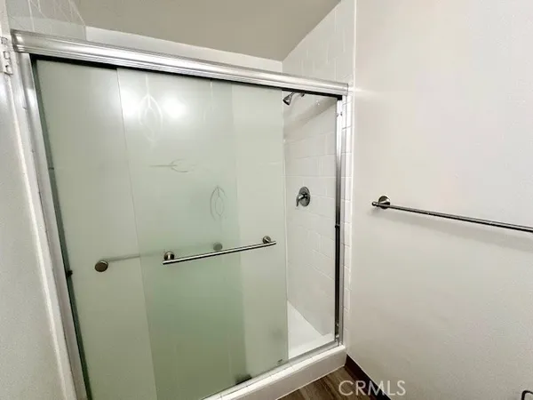 a bathroom with a glass shower door