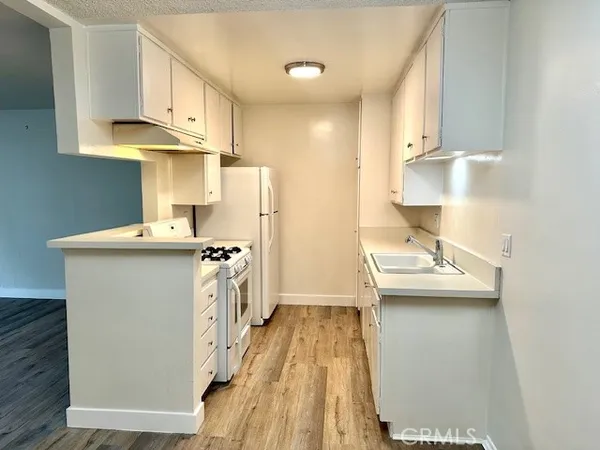 a kitchen with kitchen island a sink appliances and cabinets