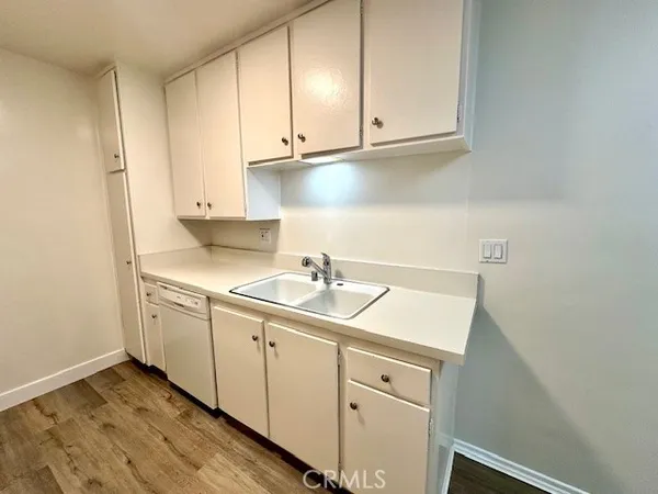 a kitchen with a sink cabinets and appliances