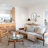 a living room with furniture and a potted plant