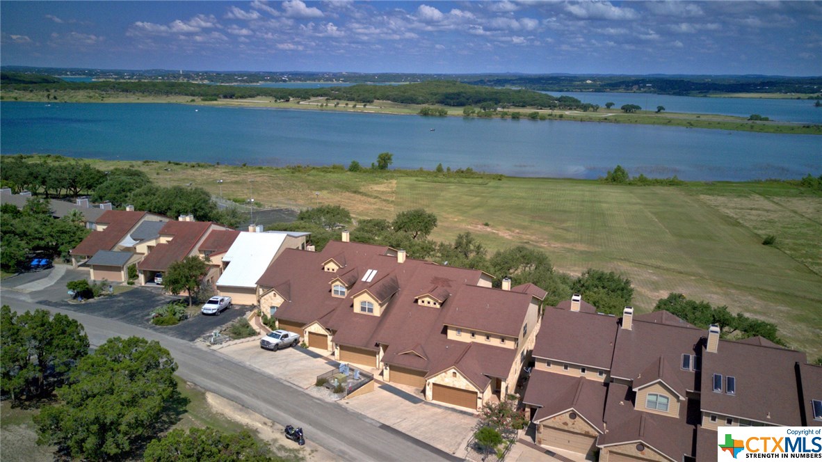 an aerial view of residential building with outdoor space and lake view