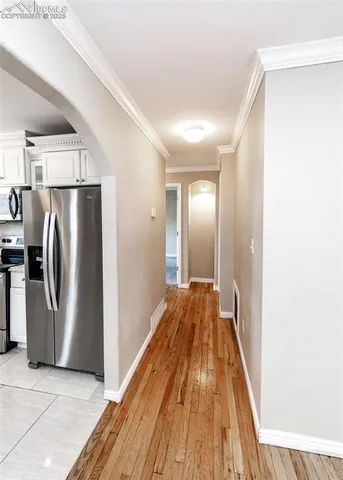 a view of a refrigerator in kitchen and wooden floor