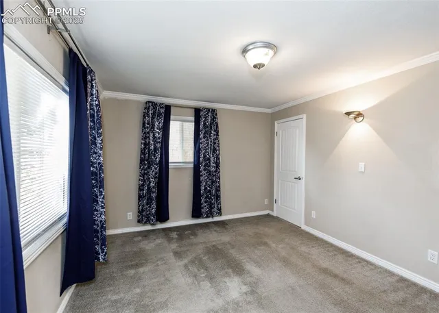 an empty room with windows and closet