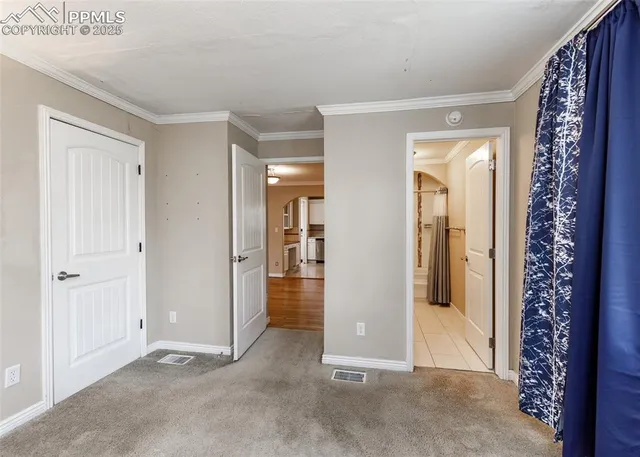 a view of a hallway with wooden shelves